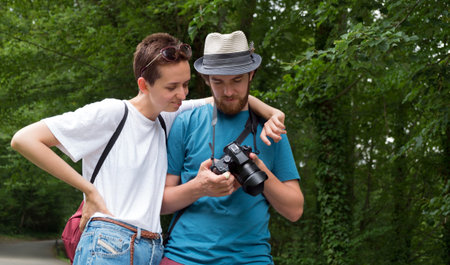 Young couple take pictures on a walk in the forestの写真素材