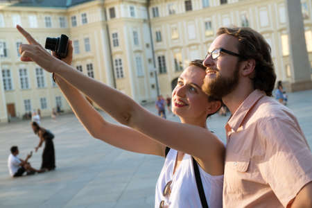 Happy young couple walking in the city on a tourist trip. Pragueの写真素材