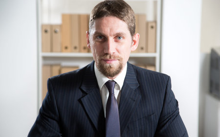 Portrait of young handsome businessman in a modern office