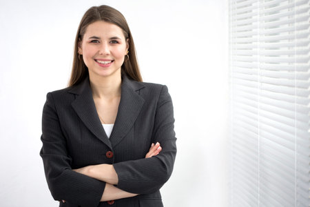 Portrait of successful business woman against a window.