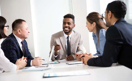 Multy-ethnic group of business people working at the office deskの写真素材