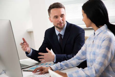 Businessman explains to colleague a new project in the modern officeの写真素材