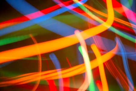 Abstract background of bright colored dynamic lightsの写真素材