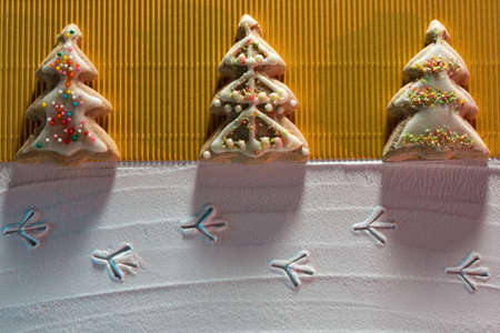 ? hristmas card with? hristmas tree cookies and image of bird footprints on the snow and place for textの写真素材