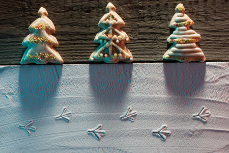 ? hristmas card with? hristmas tree cookies and image of bird footprints on the snow and place for...