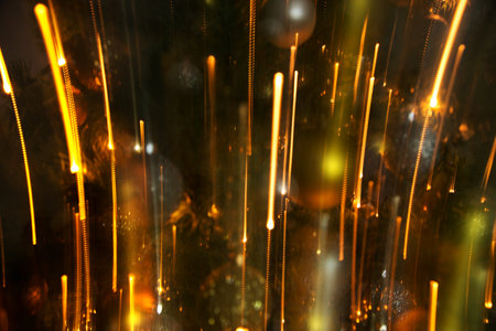 Abstract background of bright colored dynamic lights against the background of christmas decorationsの写真素材