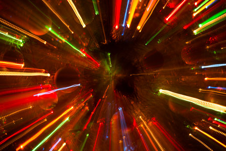 Abstract background of bright colored dynamic lights against the background of christmas decorationsの写真素材