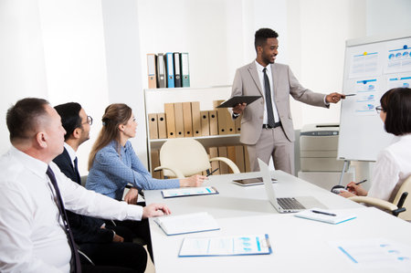 Group of multy-ethnic business people having a meeting using a white board in an office togetherの写真素材