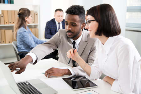 Businessman explains to colleague a new project in the modern officeの写真素材