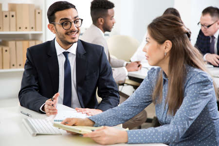 Businessman explains to colleague a new project in the modern officeの写真素材
