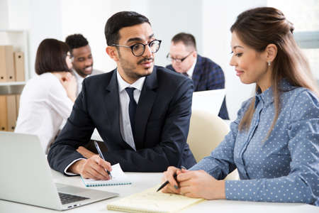 Businessman explains to colleague a new project in the modern officeの写真素材