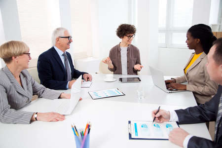 Businesswoman explains to colleague a new project in the modern officeの写真素材