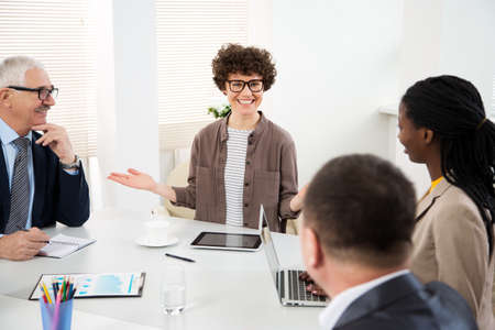 Businesswoman explains to colleague a new project in the modern officeの写真素材