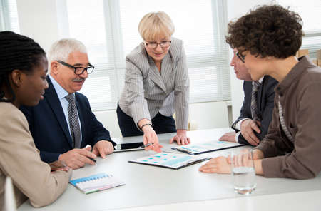 Businesswoman explains to colleague a new project in the modern officeの写真素材