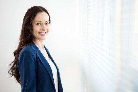 Portrait of successful business woman against a window.の写真素材