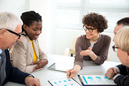 Businesswoman explains to colleague a new project in the modern officeの写真素材