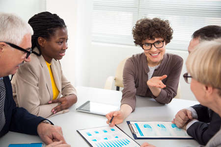 Businesswoman explains to colleague a new project in the modern officeの写真素材