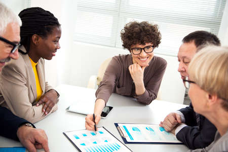 Businessman explains to colleague a new project in the modern officeの写真素材