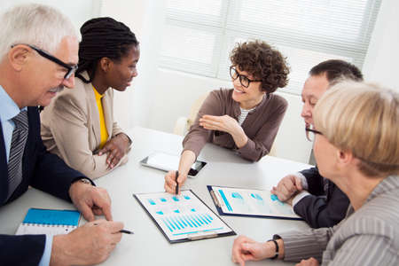 Businesswoman explains to colleague a new project in the modern officeの写真素材