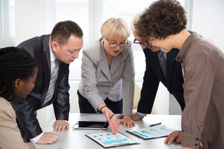 Businesswoman explains to colleague a new project in the modern officeの写真素材
