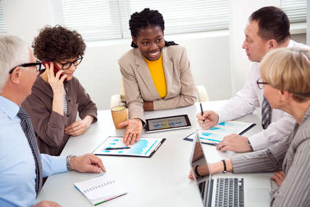 African businesswoman explains to colleague a new project in the modern officeの写真素材