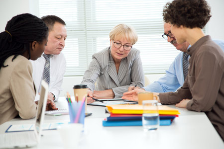 Businesswoman explains to colleague a new project in the modern office