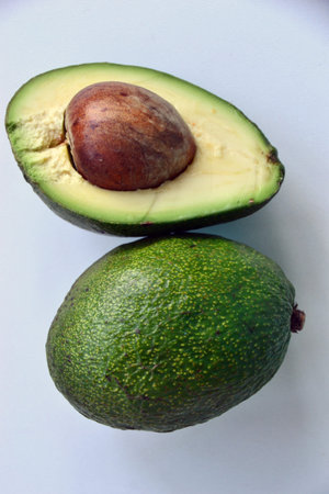 Avocado. Whole and half with seed