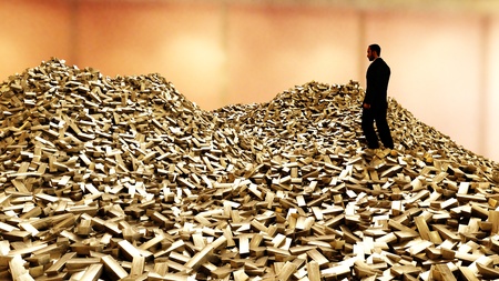 Man on pile of gold bars. business concept. 3d renderingの写真素材