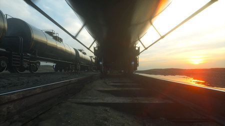Freight train oil tankers. Against Sunrise. 3d rendering.