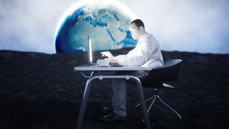Young busy businessman working on the moon.Space. African male looking into the screen of the laptop on the desk. Creative workspace concept. 3d rendering.の写真素材