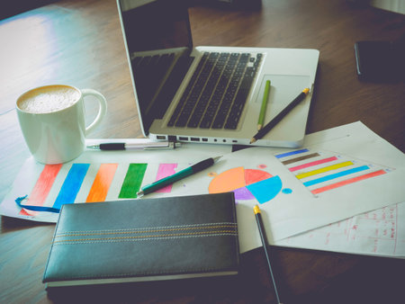 Business table ,computer, document, graph, numbers The workplace of business peopleの写真素材