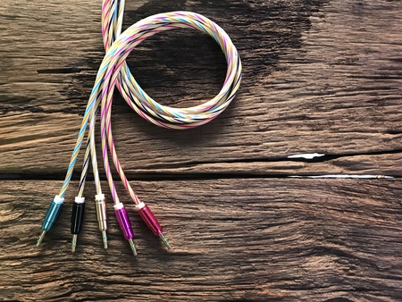 Colorful auxiliary lines on old wood floor with the concept of technology, cable, mobile peripherals, entertainment, modernity, advancement, connectivity.の写真素材