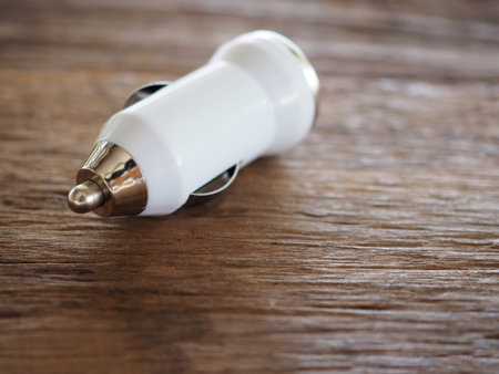 White USB Car Charger on a wooden board with technology and energy concept To facilitate And modern...