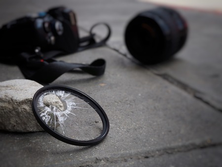 The camera dropped to the ground, causing the filter to break, the len and the body damaged. In the accident insurance concept on propertyの写真素材