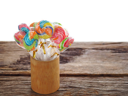 Colorful lollipop on the wooden board in the children's fun concept, joy, cheerfulness, happiness