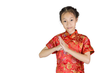 Asian girl wearing red Chinese suit on white background during traditional chinese new year festival,girl with congratulation gestureの写真素材