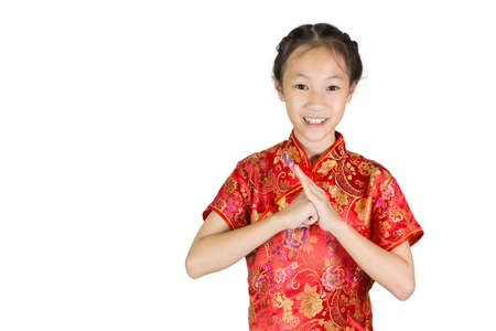 Asian girl wearing red Chinese suit on white background during traditional chinese new year festival,girl with congratulation gestureの写真素材