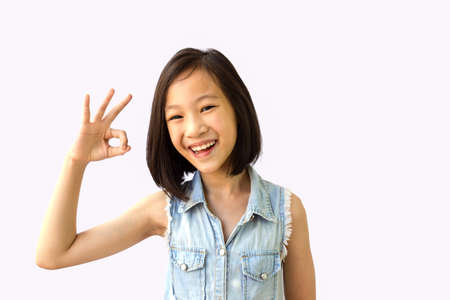 Asian girl on white background,ok,okay,smiling,happyの写真素材