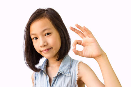 Asian girl on white background,ok,okay,smiling,happyの写真素材