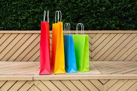 Paper shopping bags with shopping bags on wooden backgroundの写真素材