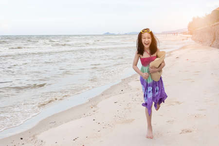 Happy little girl playing on the beach,summertime fun conceptの写真素材