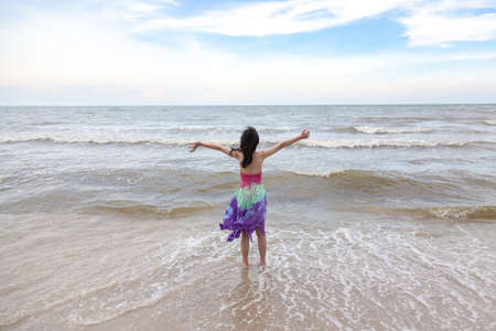 Happy little girl playing on the beach,summertime fun conceptの写真素材