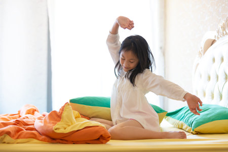 Beautiful girl waking up in her bed,Asian girl smiling and stretching,healthy lifestyle,wellness...