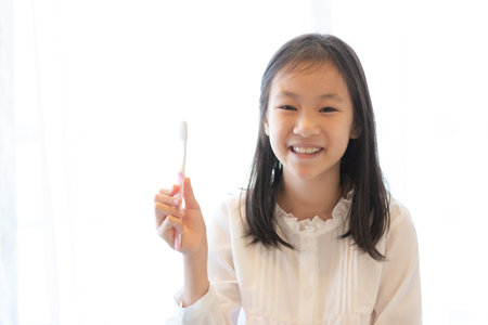 Asian girl smiles and holds a toothbrush,healthy teeth conceptの写真素材