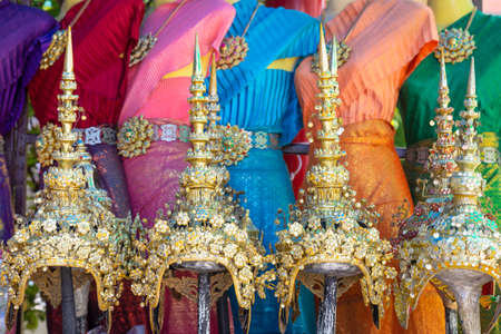 Vibrant traditional Thai silk dresses and Headdress,accessories displayの写真素材
