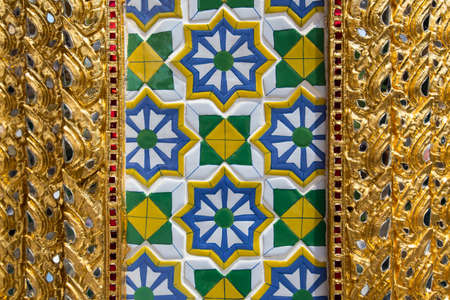 Beautiful,Close up ceramic and golden  pattern background in the buddhist temple at Grand Palace,Bangkok,Thailandの写真素材