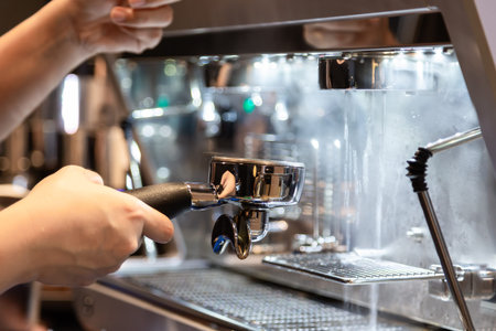 Barista preparing coffee cleaning the espresso machine and serving coffee