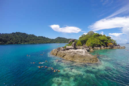 Snorkeling Trips,tourist are snorkeling watching fish in the sea ,seascape mountain view,(Koh Chang,Trat,Thailand.)の写真素材