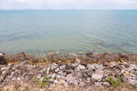 Coastal protection,waves breaking on a rocky breakwater at the beach in Koh Chang,Trat,Thailand