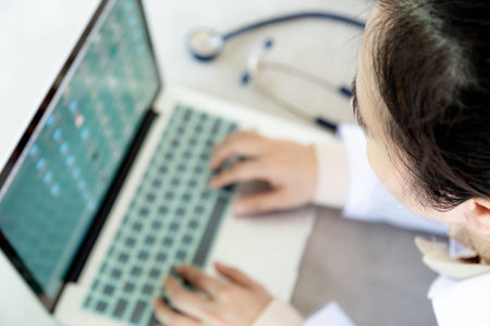 Top view,female doctor working on desk with laptop computer and stethoscope,closeup health...